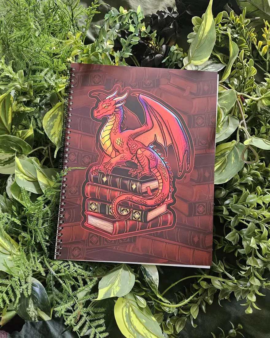 Acorn & Crow's Gideon the Book Dragon spiral notebook on greenery